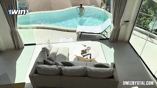 A beautiful woman enjoys a vacation by the swimming pool
