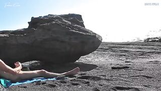 Nude beauty rubs her tits and cunts on the beach while jerking off a guy