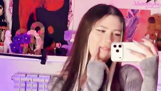 A girl plays with a big dildo in front of the mirror