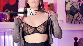 A girl plays with a big dildo in front of the mirror