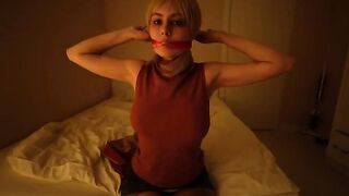 A girl plays a sexy role, teasing with her gaze